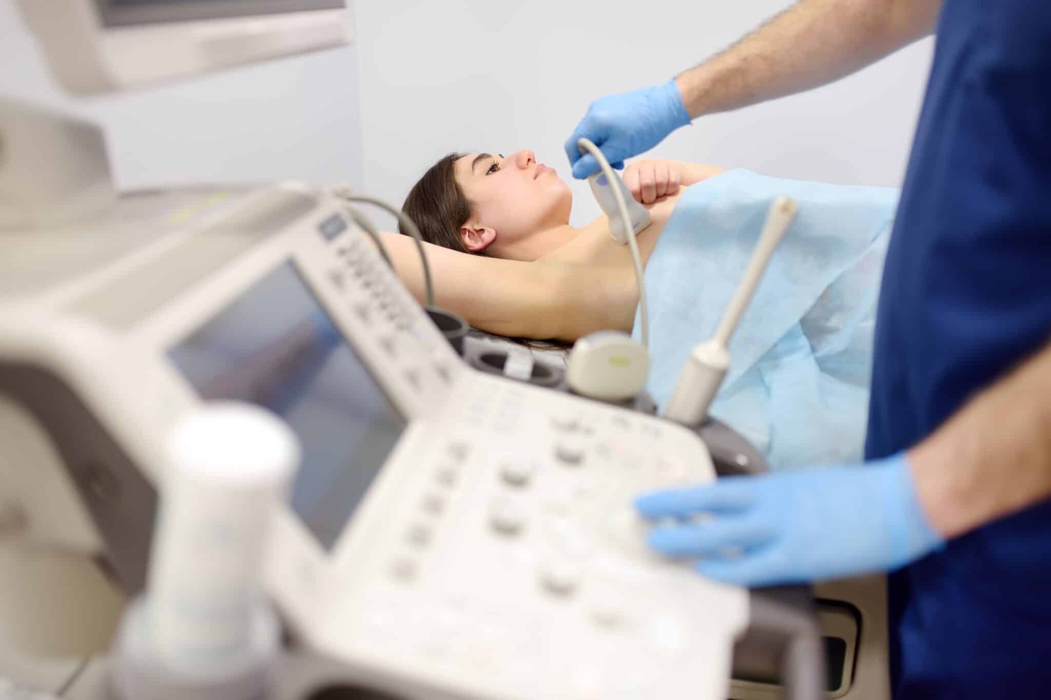 mammologist,doctor,examines,a,woman,breasts,and,lymph,nodes,using